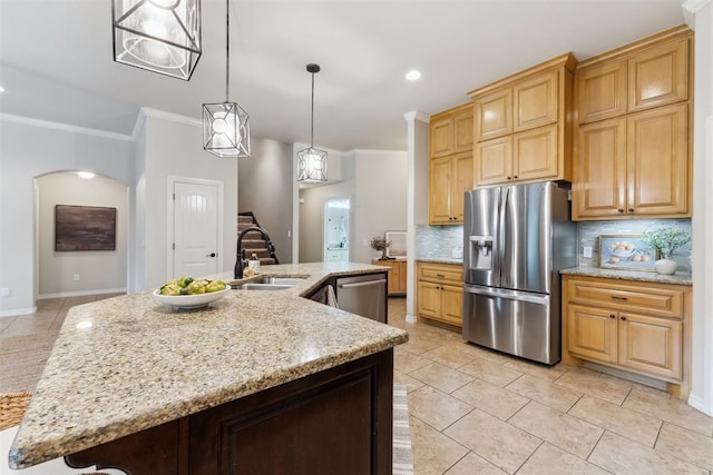 4932 Mahogany Dr, Edmond, OK 73025 - kitchen with appliances with stainless steel finishes, a sink, crown molding, tasteful backsplash, and light stone counters