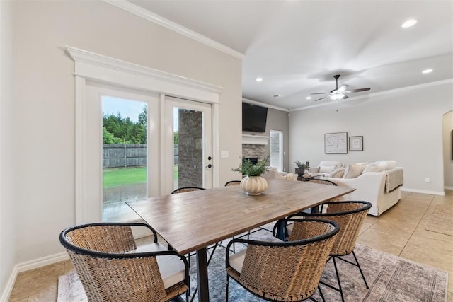 4932 Mahogany Dr, Edmond, OK 73025 - dining room with ornamental molding, recessed lighting, a stone fireplace, baseboards, and ceiling fan