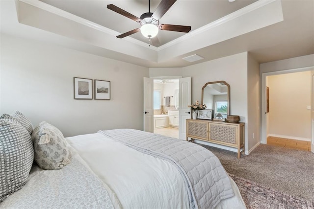 4932 Mahogany Dr, Edmond, OK 73025 - bedroom with a raised ceiling, ornamental molding, carpet, baseboards, and connected bathroom