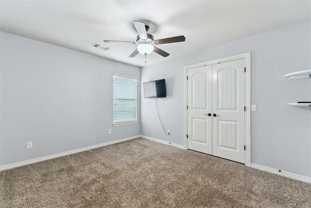 4932 Mahogany Dr, Edmond, OK 73025 - unfurnished bedroom featuring carpet floors, a closet, baseboards, and ceiling fan