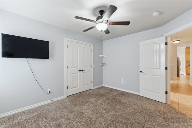 4932 Mahogany Dr, Edmond, OK 73025 - unfurnished bedroom featuring freestanding refrigerator, light carpet, a closet, and baseboards