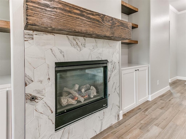 404 Braxton Way, Yukon, OK 73099 - detailed view of wood finished floors, crown molding, a tile fireplace, and baseboards
