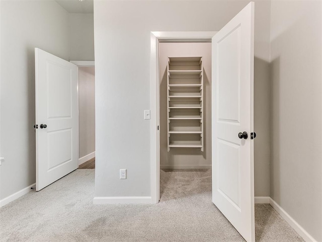 404 Braxton Way, Yukon, OK 73099 - unfurnished bedroom featuring a spacious closet, carpet, baseboards, and a closet