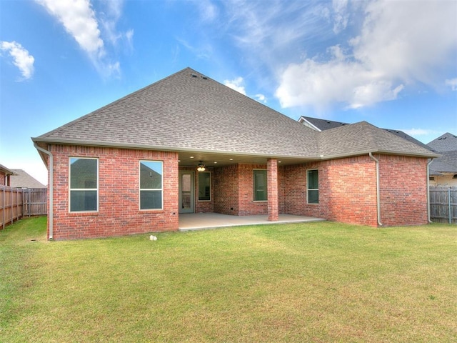 404 Braxton Way, Yukon, OK 73099 - rear view of property featuring a shingled roof, brick siding, and a patio area