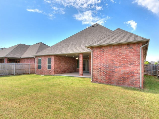 404 Braxton Way, Yukon, OK 73099 - rear view of house with brick siding, roof with shingles, and a patio
