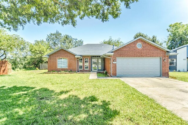 3305 Outpost Cir, Norman, OK 73072 - ranch-style home with driveway, a garage, and brick siding