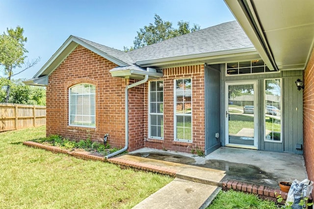 3305 Outpost Cir, Norman, OK 73072 - view of exterior entry with brick siding and a shingled roof