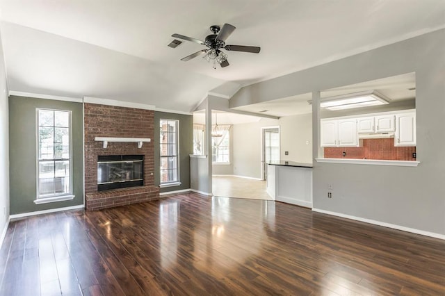 3305 Outpost Cir, Norman, OK 73072 - unfurnished living room with baseboards, a ceiling fan, wood finished floors, lofted ceiling, and crown molding