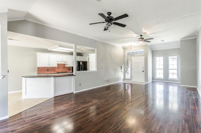 3305 Outpost Cir, Norman, OK 73072 - unfurnished living room featuring ceiling fan, wood finished floors, baseboards, and ornamental molding