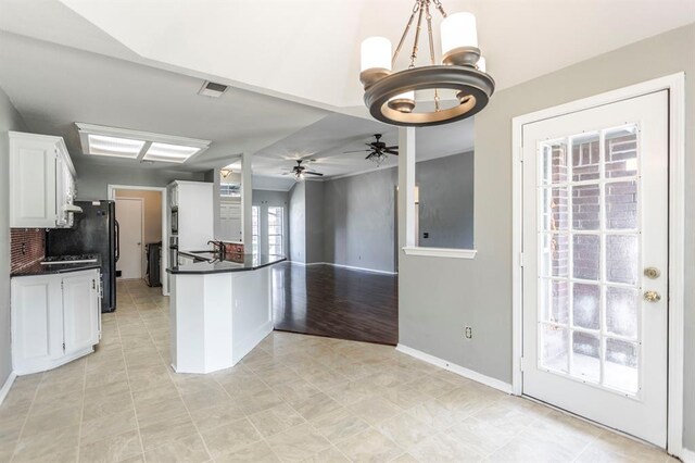 3305 Outpost Cir, Norman, OK 73072 - kitchen with dark countertops, white cabinets, ceiling fan, and baseboards