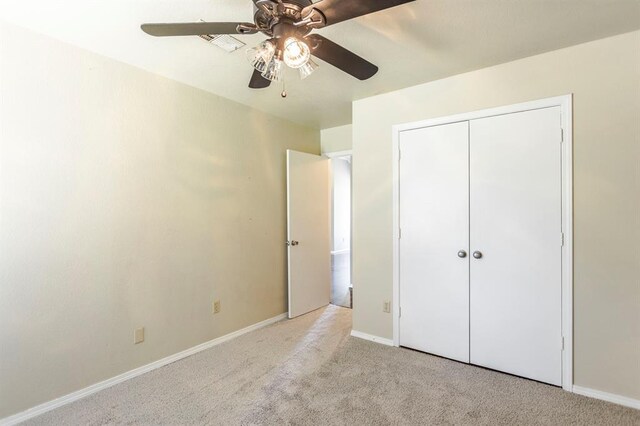 3305 Outpost Cir, Norman, OK 73072 - unfurnished bedroom with carpet floors, baseboards, a closet, and a ceiling fan