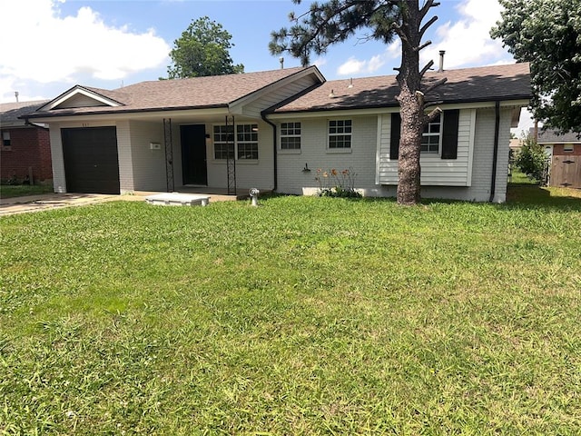865 NW 14th St, Moore, OK 73160 - back of house with brick siding, a garage, concrete driveway, and a lawn