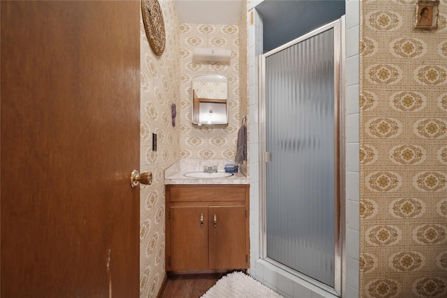 1392 Robin Hood Rd, Eufaula, OK 74432 - full bath featuring vanity, a shower stall, wallpapered walls, and wood finished floors