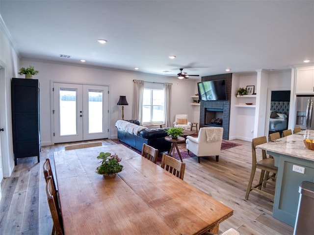 11611 Carefree Ln, Shawnee, OK 74804 - dining space with ornamental molding, a ceiling fan, a brick fireplace, french doors, and recessed lighting