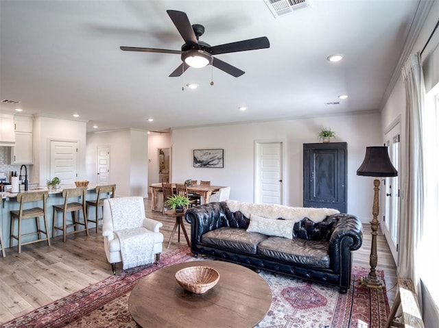 11611 Carefree Ln, Shawnee, OK 74804 - living area featuring light wood-style flooring, ceiling fan, crown molding, and recessed lighting