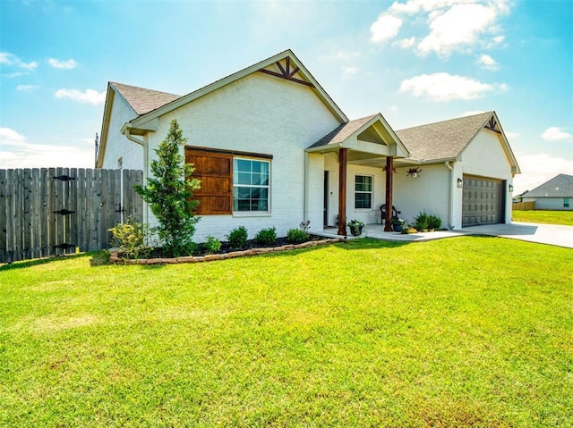 11611 Carefree Ln, Shawnee, OK 74804 - view of front facade with concrete driveway, a garage, roof with shingles, and brick siding