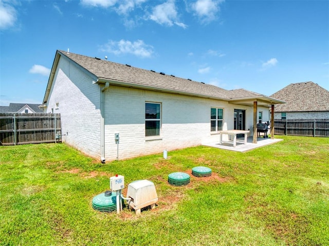 11611 Carefree Ln, Shawnee, OK 74804 - rear view of house with brick siding, a patio area, and a shingled roof