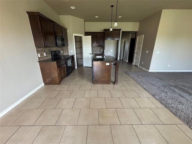 11232 NW 101st St, Yukon, OK 73099 - kitchen with black appliances, dark countertops, tasteful backsplash, recessed lighting, and an island with sink