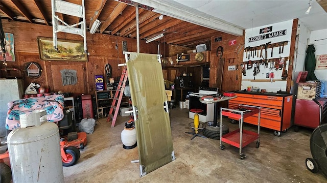 4001 N Bryan Ave, Shawnee, OK 74804 - miscellaneous room with a workshop area, wood walls, and concrete floors