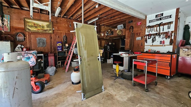 4001 N Bryan Ave, Shawnee, OK 74804 - miscellaneous room with a workshop area, wood walls, and concrete floors