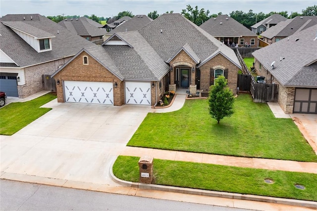 4813 Hidalgo Ave, Mustang, OK 73064 - view of front of home with brick siding, a garage, a residential view, roof with shingles, and driveway