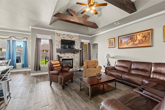 4813 Hidalgo Ave, Mustang, OK 73064 - living room featuring ceiling fan, a fireplace, wood finished floors, baseboards, and arched walkways