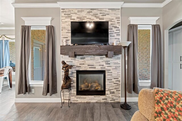 4813 Hidalgo Ave, Mustang, OK 73064 - living area with a fireplace, wood finished floors, crown molding, and baseboards