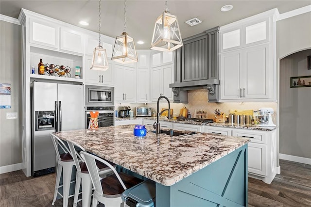 4813 Hidalgo Ave, Mustang, OK 73064 - kitchen featuring appliances with stainless steel finishes, an island with sink, baseboards, light stone counters, and recessed lighting