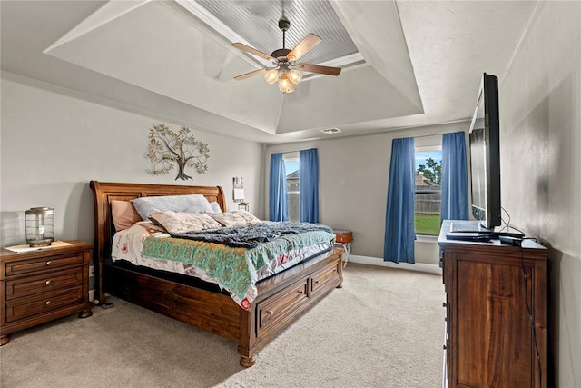 4813 Hidalgo Ave, Mustang, OK 73064 - bedroom featuring a raised ceiling, light carpet, and ceiling fan