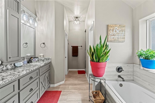 4813 Hidalgo Ave, Mustang, OK 73064 - bathroom with vanity, a garden tub, and baseboards