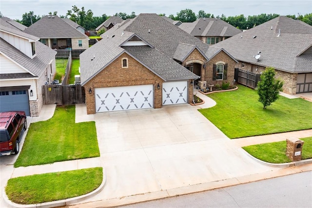4813 Hidalgo Ave, Mustang, OK 73064 - view of front of home featuring brick siding, a shingled roof, a garage, and driveway