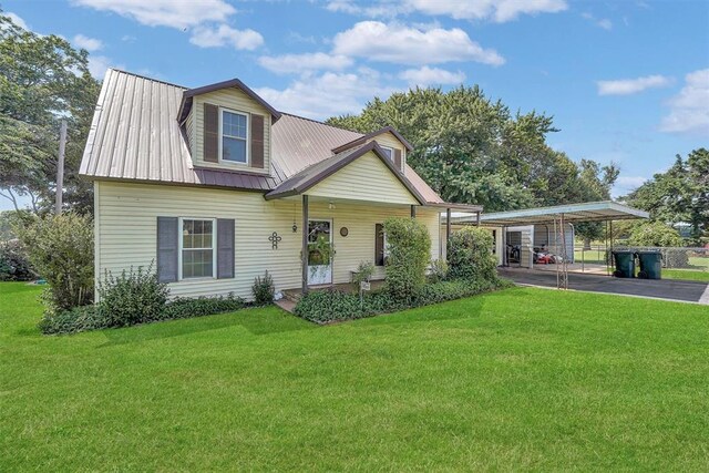 409 S Mcdonald St, Dill City, OK 73641 - view of front facade featuring a front lawn, driveway, and metal roof
