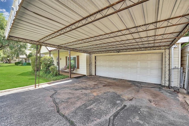 409 S Mcdonald St, Dill City, OK 73641 - garage featuring an attached carport and driveway