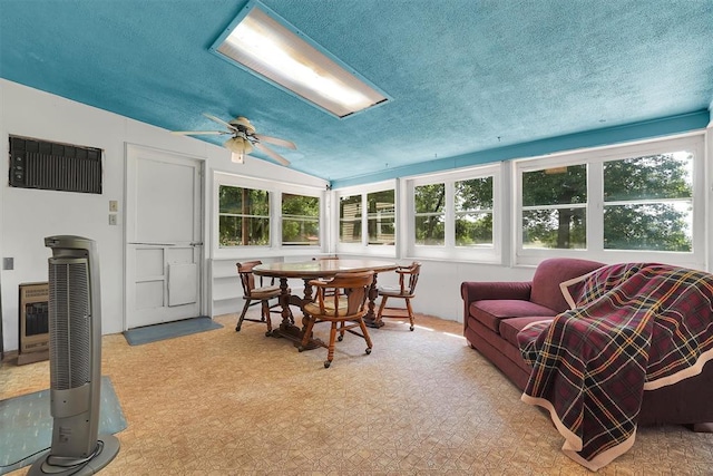 409 S Mcdonald St, Dill City, OK 73641 - sunroom / solarium with plenty of natural light, lofted ceiling, heating unit, and a textured ceiling