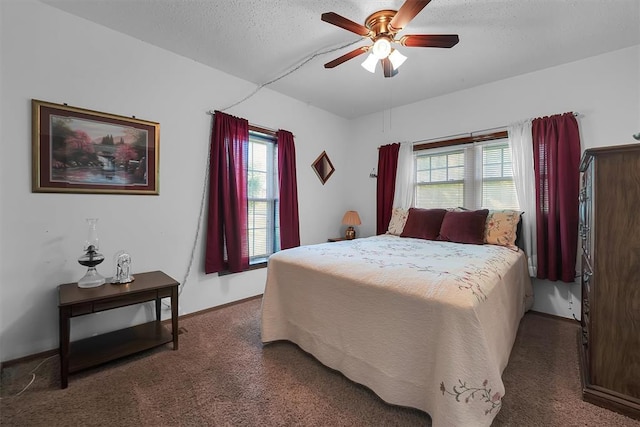 409 S Mcdonald St, Dill City, OK 73641 - bedroom with carpet flooring, multiple windows, a textured ceiling, a ceiling fan, and baseboards