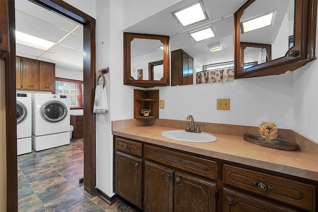 409 S Mcdonald St, Dill City, OK 73641 - bathroom featuring washer and clothes dryer, vanity, and stone finish floors