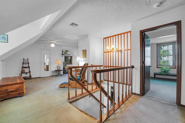 409 S Mcdonald St, Dill City, OK 73641 - stairs with carpet flooring, a textured ceiling, a ceiling fan, a skylight, and a baseboard radiator