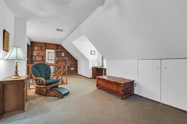409 S Mcdonald St, Dill City, OK 73641 - sitting room featuring carpet flooring, a textured ceiling, vaulted ceiling, ceiling fan, and built in shelves