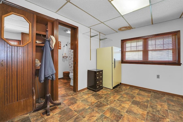 409 S Mcdonald St, Dill City, OK 73641 - interior space featuring a paneled ceiling and dark stone finish floors