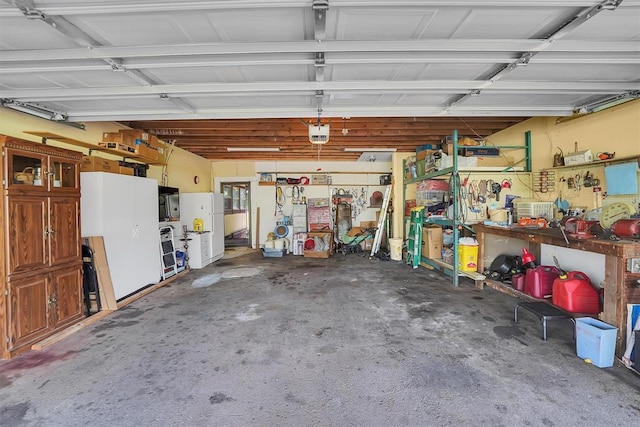 409 S Mcdonald St, Dill City, OK 73641 - garage featuring a workshop area, freestanding refrigerator, and a garage door opener