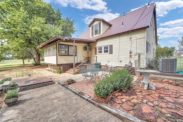 409 S Mcdonald St, Dill City, OK 73641 - back of house featuring cooling unit, a patio, and metal roof