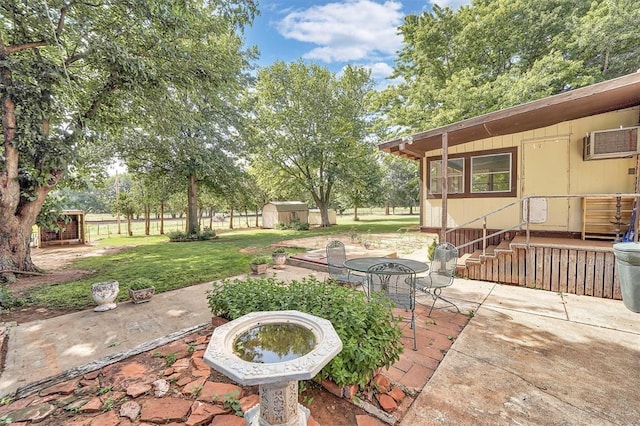 409 S Mcdonald St, Dill City, OK 73641 - view of patio / terrace featuring a wall unit AC