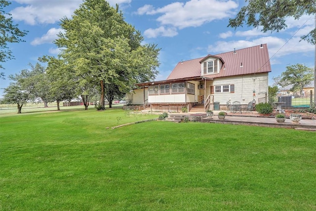 409 S Mcdonald St, Dill City, OK 73641 - rear view of house with metal roof and a yard