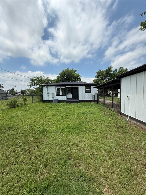1707 N Louisa Ave, Shawnee, OK 74804 - back of property with an outdoor structure and cooling unit