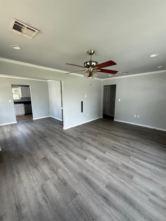 1707 N Louisa Ave, Shawnee, OK 74804 - unfurnished living room with ornamental molding, ceiling fan, baseboards, dark wood finished floors, and recessed lighting