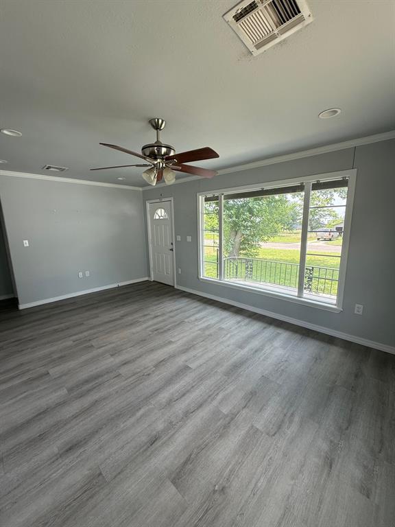 1707 N Louisa Ave, Shawnee, OK 74804 - unfurnished room with baseboards, ceiling fan, wood finished floors, crown molding, and recessed lighting