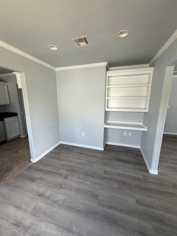 1707 N Louisa Ave, Shawnee, OK 74804 - unfurnished living room featuring baseboards, crown molding, dark wood-style floors, and recessed lighting