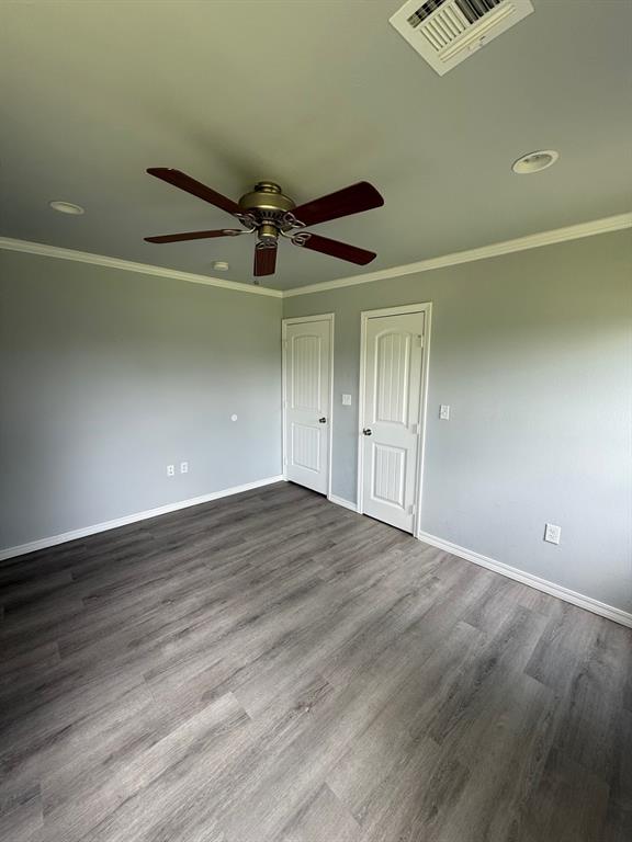 1707 N Louisa Ave, Shawnee, OK 74804 - spare room featuring a ceiling fan, baseboards, dark wood finished floors, ornamental molding, and recessed lighting