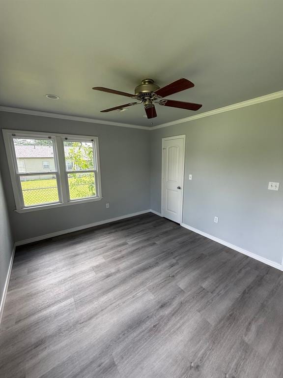 1707 N Louisa Ave, Shawnee, OK 74804 - spare room featuring a ceiling fan, baseboards, ornamental molding, and dark wood finished floors
