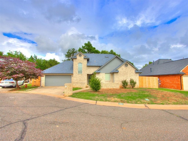1312 Every Dr, Edmond, OK 73034 - view of front of property featuring brick siding, concrete driveway, a garage, and a shingled roof
